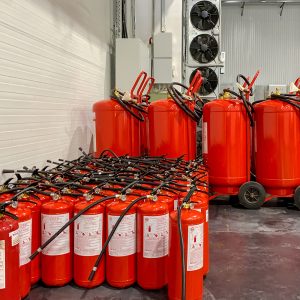 Kiev, Ukraine, July 2021: - A lot of fire extinguishers. Protection and security in case of fire. Industrial background. Close-up.